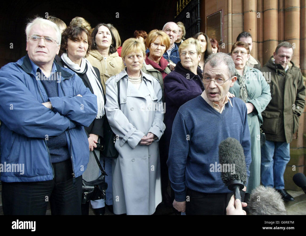 Mickey McKinney (front), who lost his brother William in the 1972 shootings, speaks to the media following the Bloody Sunday Inquiry at the Guildhall in Londonderry. The Bloody Sunday Tribunal is to take no action against journalists who refused to name their sources or paramilitaries who refused to identify colleagues, chairman Lord Saville said today. Stock Photo