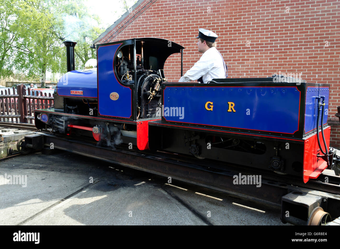 Narrow gauge steam locomotive on a manual turntable at the Bressingham Steam Museum and Gardens, near Diss in Norfolk, England. Stock Photo