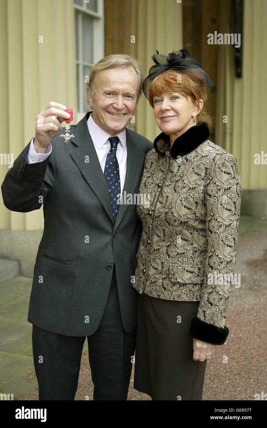 FOREIGN USE ONLY: Daily Mail cartoonist Stanley McMurtry, 67, alongside his wife Liz, as he holds the OBE which he received from Britain's Queen Elizabeth II at Buckingham Palace, London. He said the Queen told him she was 'aware' of his cartoons and that they had given her 'great pleasure'. Stock Photo