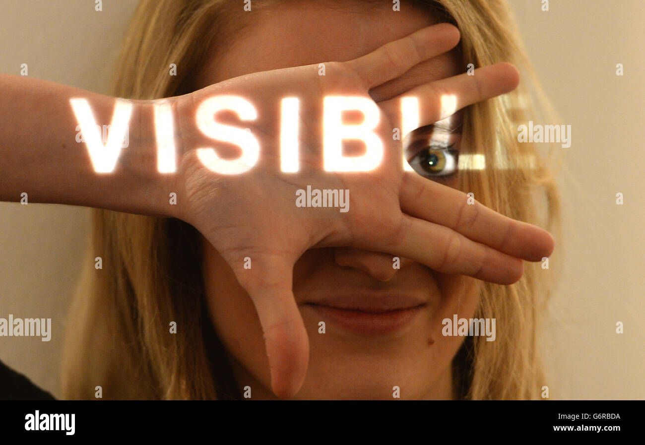 A Christie's employee poses with 'Invisible' by Giovanni Anselmo during a preview of Christie's Eyes Wide Open: An Italian Vision sale at Christie's, Mayfair, London. Stock Photo