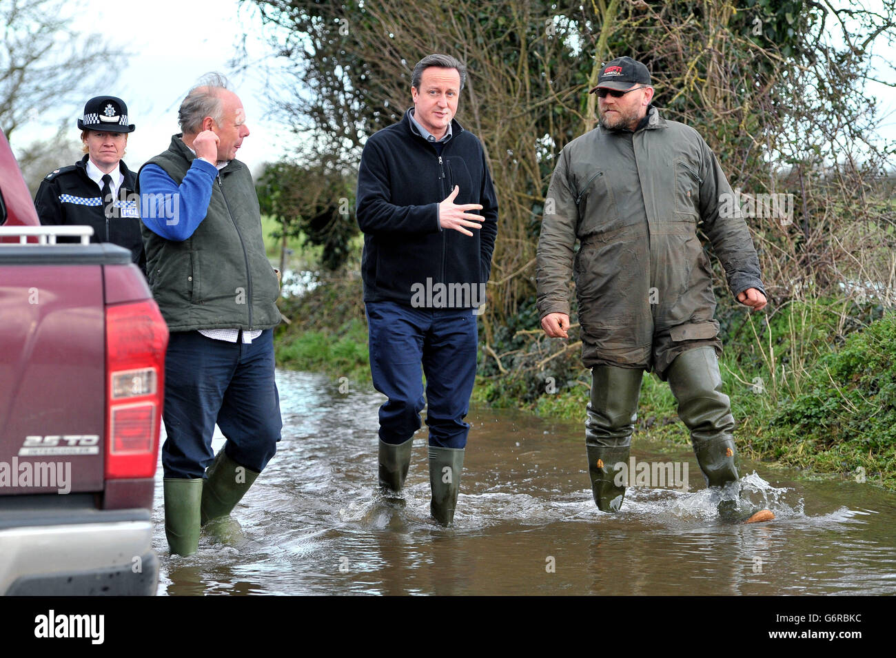 Prime Minister David Cameron with Bridgwater and West Somerset MP Ian Liddell-Grainger (2nd left), and farmer Tony Davy (right) during a visit to Goodings Farm in Fordgate, Somerset. Stock Photo
