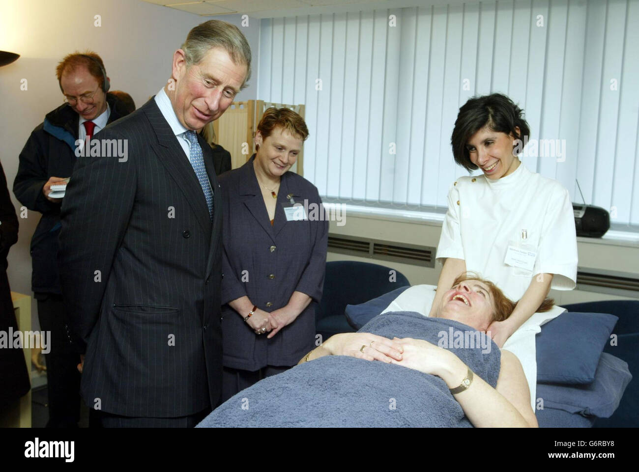 The Prince of Wales talks to Osteopath Bediz Akinciglu and patient