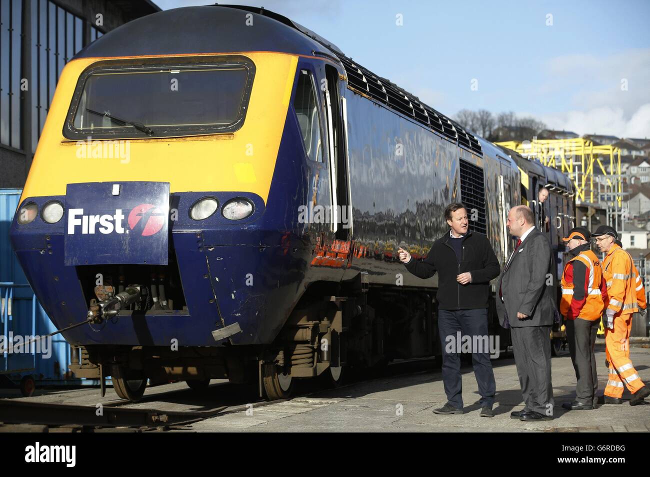 Prime Minister David Cameron (left) speaks to Deputy General Manager Andy Mellors, during his visit to the First Great Western's Laira rail depot, in Plymouth, south west England, which is used to service the operator's high speed trains. Stock Photo