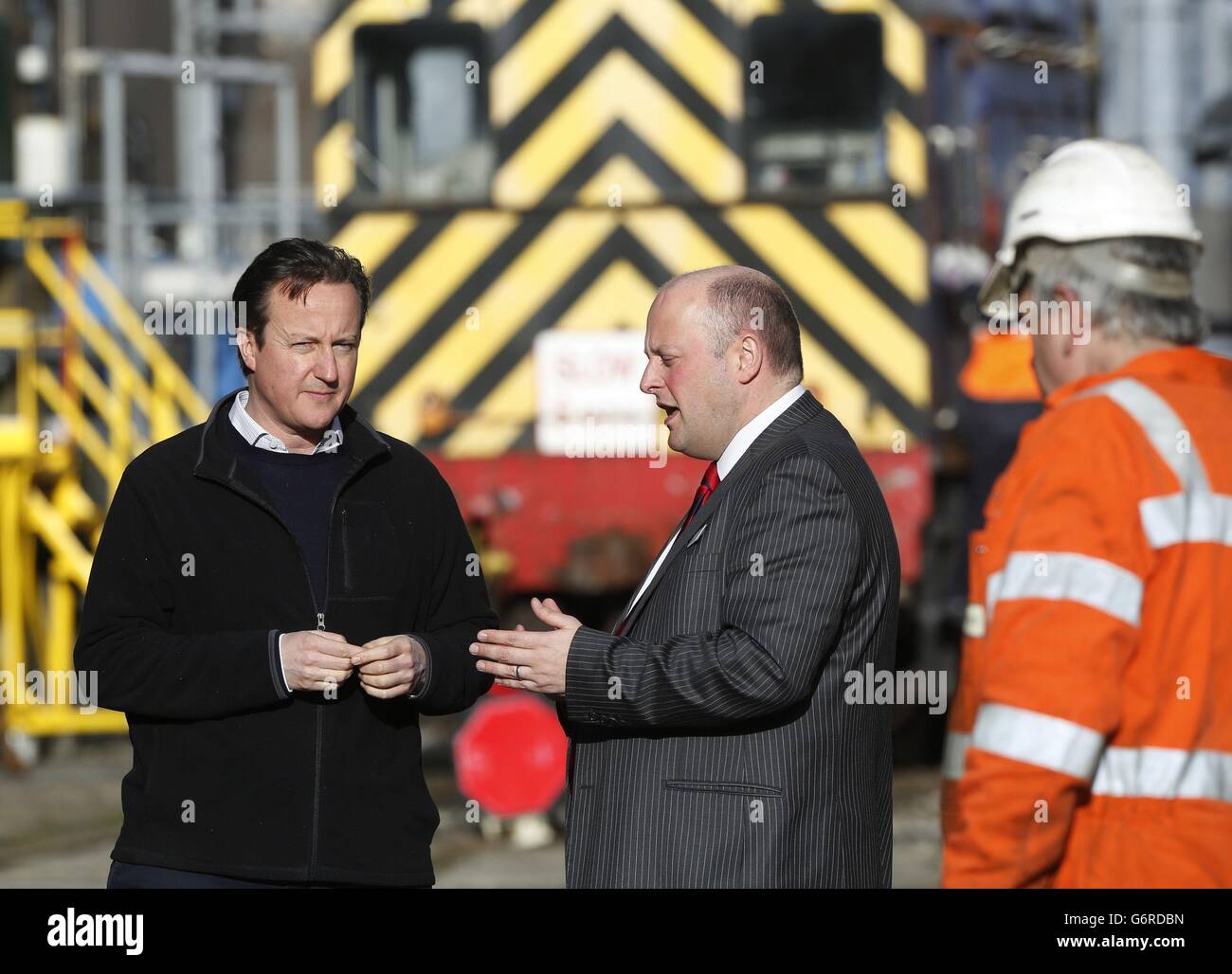 Prime Minister David Cameron (left) speaks to Deputy General Manager Andy Mellors, during his visit to the First Great Western's Laira rail depot, in Plymouth, south west England, which is used to service the operator's high speed trains. Stock Photo