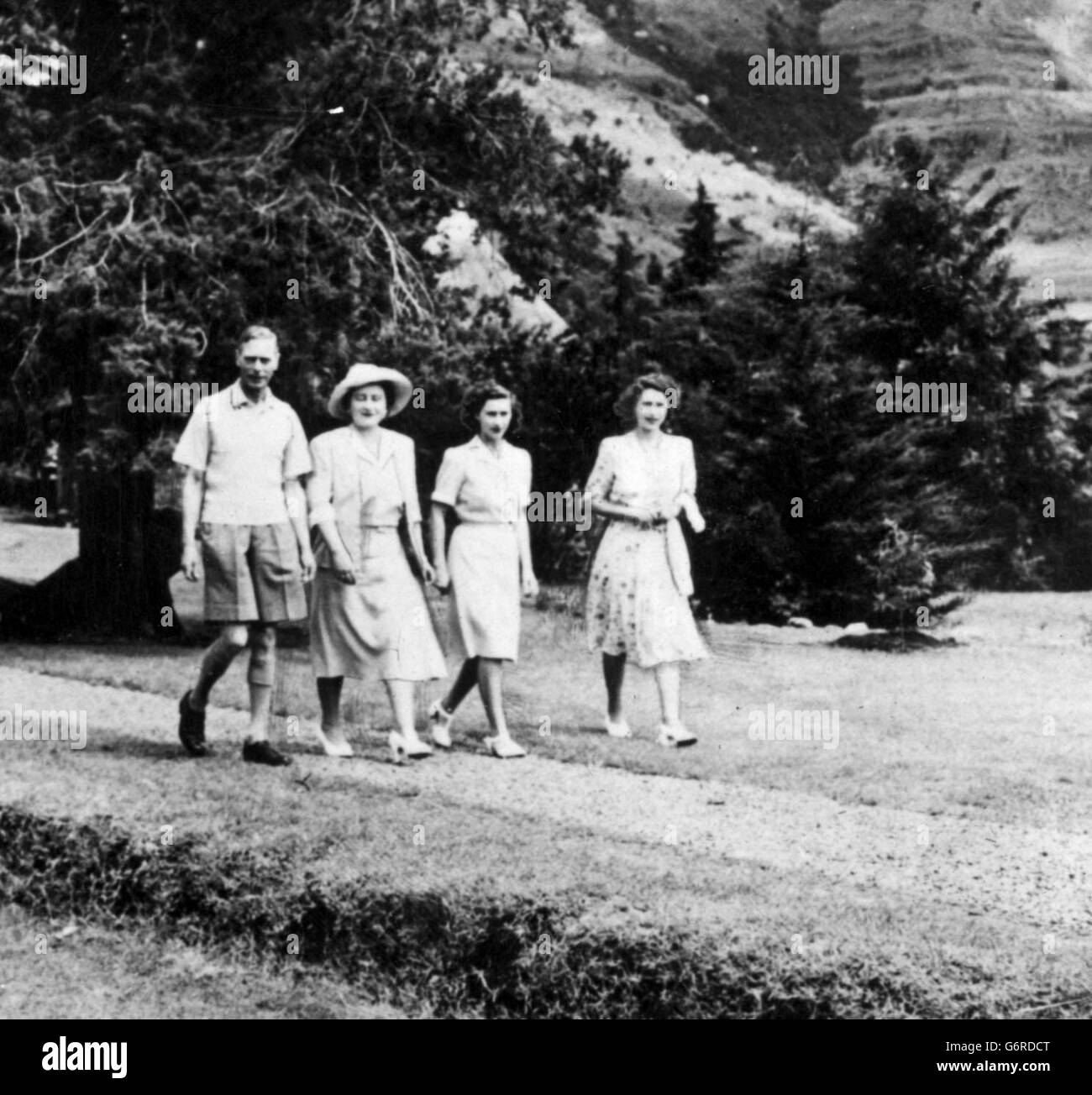 The King and Queen stroll through formal gardens a the British Representatives House at Maseru in Basutoland, with the Princess's Elizabeth and Margaret. Stock Photo