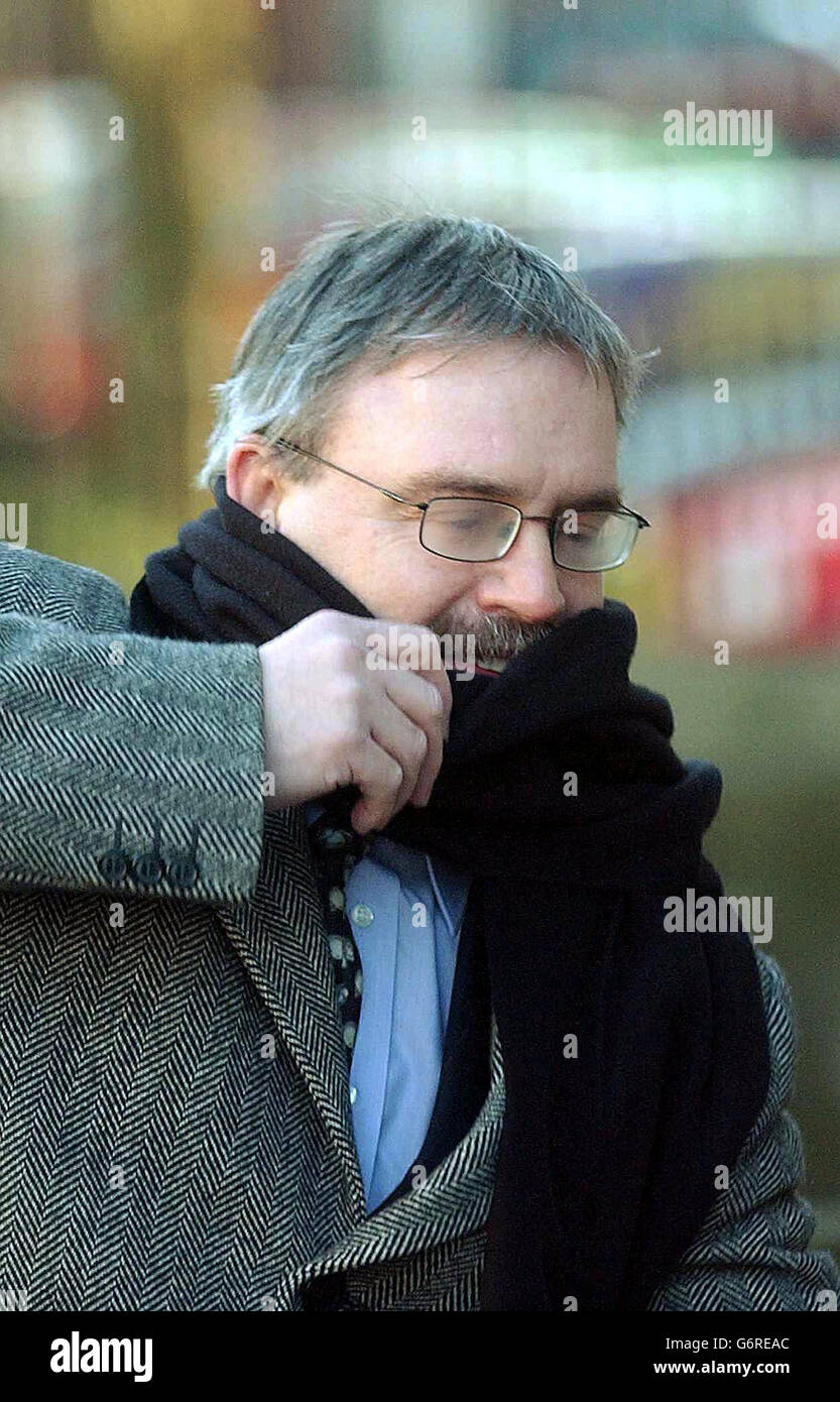 Mr Nelson Bland shields his face as he arrives at Nottingham Crown Court. Mr Bland is the lover of Carol Croydon, 37, an accountant who allegedly attacked her husband Philip Croydon with a cheese knife in a hotel room. Mr Croydon, 49, who ran his own upholstery business, was found with 22 separate stab wounds in room 328 at the Hilton Hotel at East Midlands airport on April 25 last year. Stock Photo