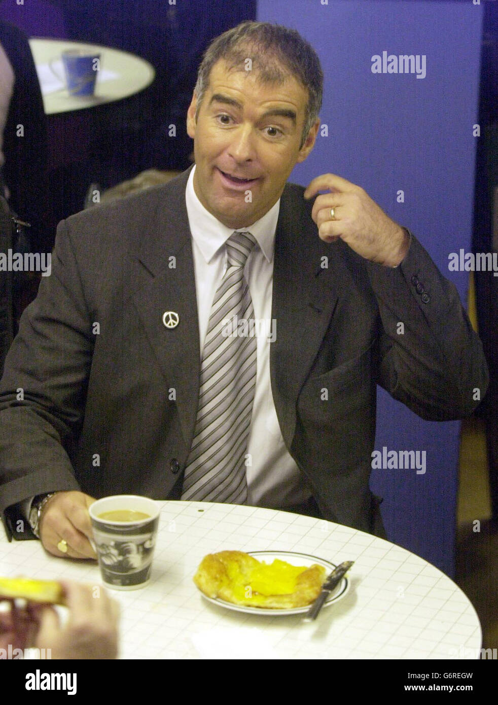 Scottish Socialist Party leader Tommy Sheridan enjoys a cup of tea and a pastry at the Purple Haze Cafe in Edinburgh, where the Scottish Cannabis Coffeeshop Movement (SCCM) had invited people to openly use cannabis. Mr Sheridan called on police to turn a blind eye to the use of cannabis - which he said was no more a crime than doing a jigsaw - as the drug was officially downgraded to class C. Stock Photo