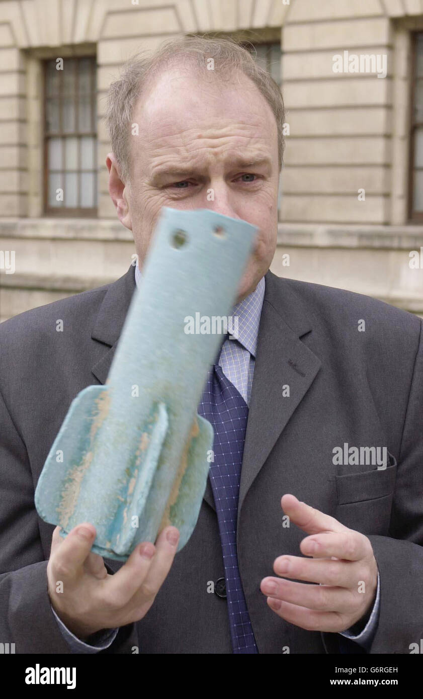 Conservative MP Ian Liddell- Grainger holds aloft one of two missile-casings found washed ashore on the Weston-Super-Mare coastline, outside the Old War Office in central London. Mr Liddell-Grainger, who was returning the blue fibre-glass tail-fins to the MoD, today accused the ministry of a "catalogue of failures" in allowing a pallet load of missiles to be lost during a routine underwater disposal exercise which went wrong in March 2002. Stock Photo