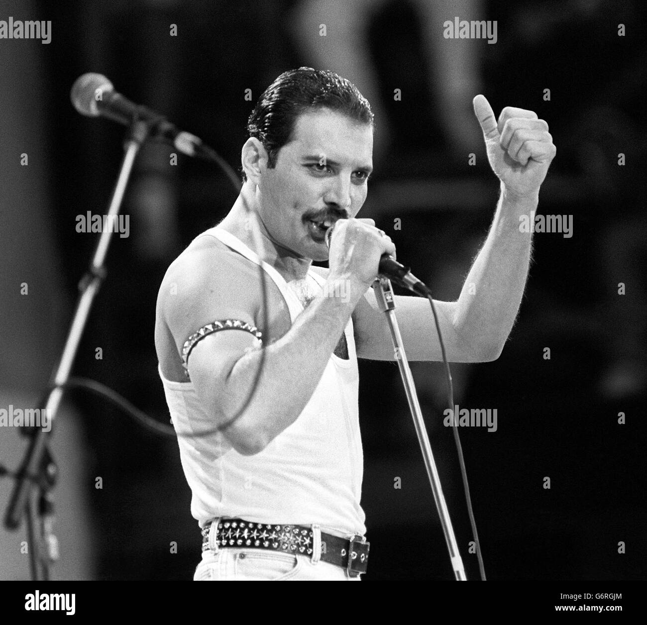 Freddie Mercury, of the pop band Queen, performing on stage during the Live Aid concert. Stock Photo