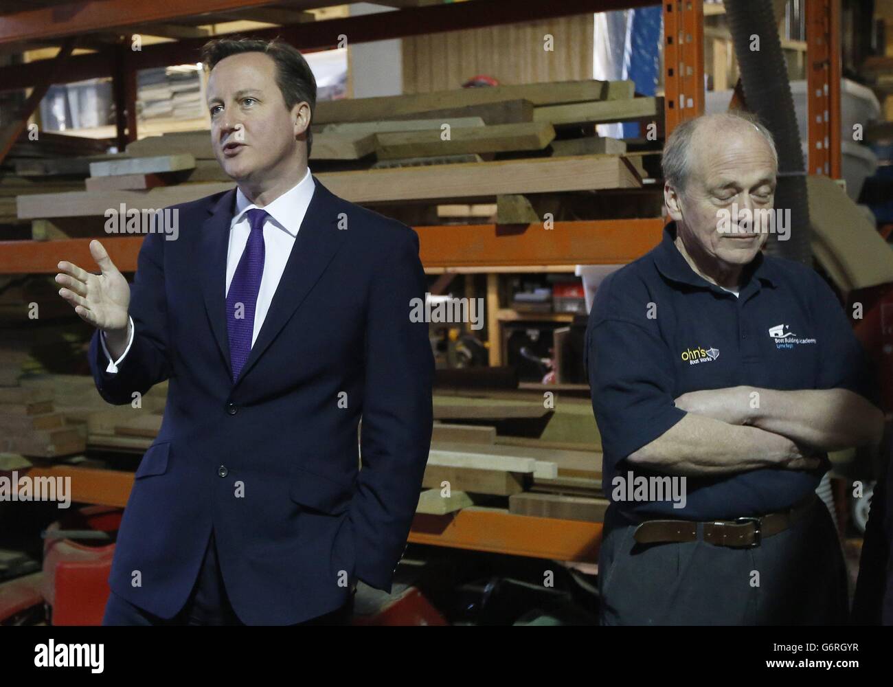 Prime Minister David Cameron (left) with boat builder and restorer John Watson during a visit to small businesses at Lots Ait Boatyard in Brentford, west London. Stock Photo