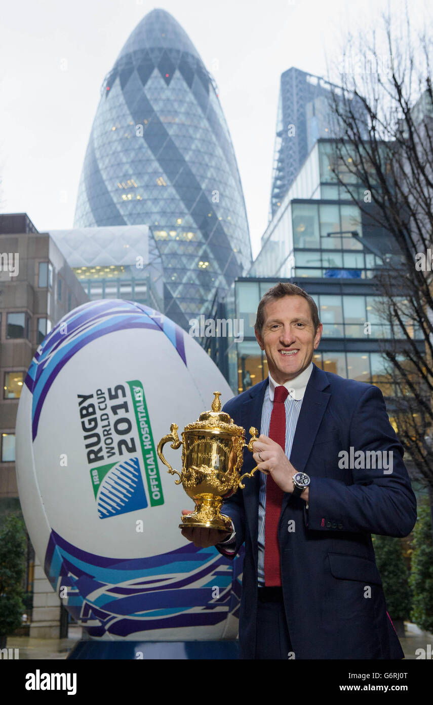 EDITORIAL USE ONLY Former England Rugby Union player Will Greenwood, holds the Web Ellis Cup in front of a four metre high rugby ball in London's Devonshire Square to announce that Rugby World Cup 2015 Travel & Hospitality packages will be going on sale on Saturday February 1 at www.rugbyworldcup.com/hospitality. Stock Photo