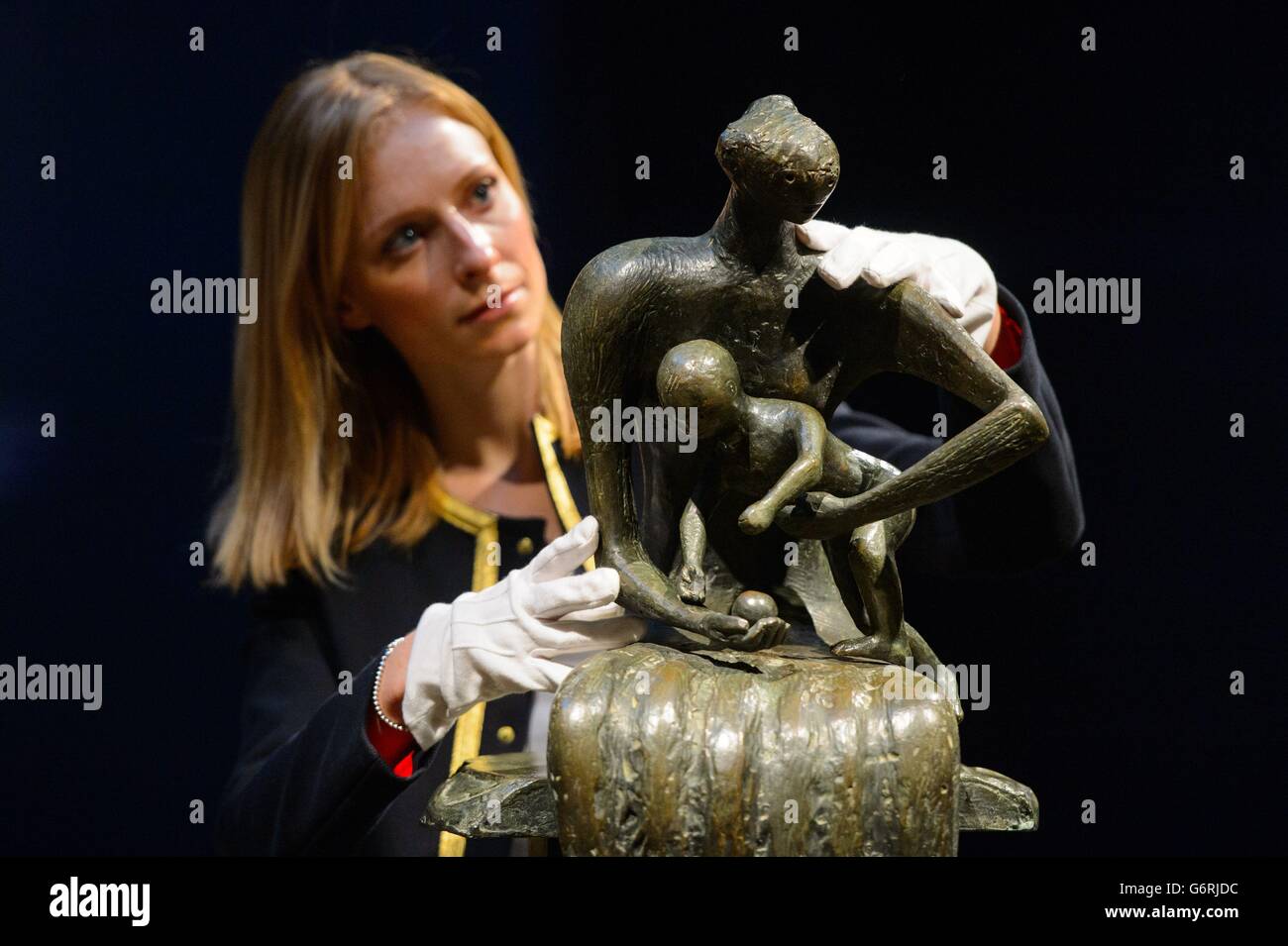 Christie's employee Amber Hailes with 'Mother and Child with Apple' by Henry Moore, which is expected to fetch &Acirc;£2.5 million as part of Christie's Impressionist, Modern and Surrealist Art sale next month. Stock Photo