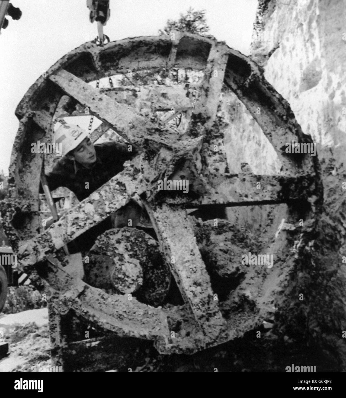 A Eurotunnel engineer inspecting a Whitaker tunnelling boring machine, which was unearthed at Hythe, Kent. The machine was used in a project in 1922-23 to dig an exploratory tunnel, which was later abandoned that year and has remained in the tunnel ever since until Eurotunnel excavated it. Stock Photo