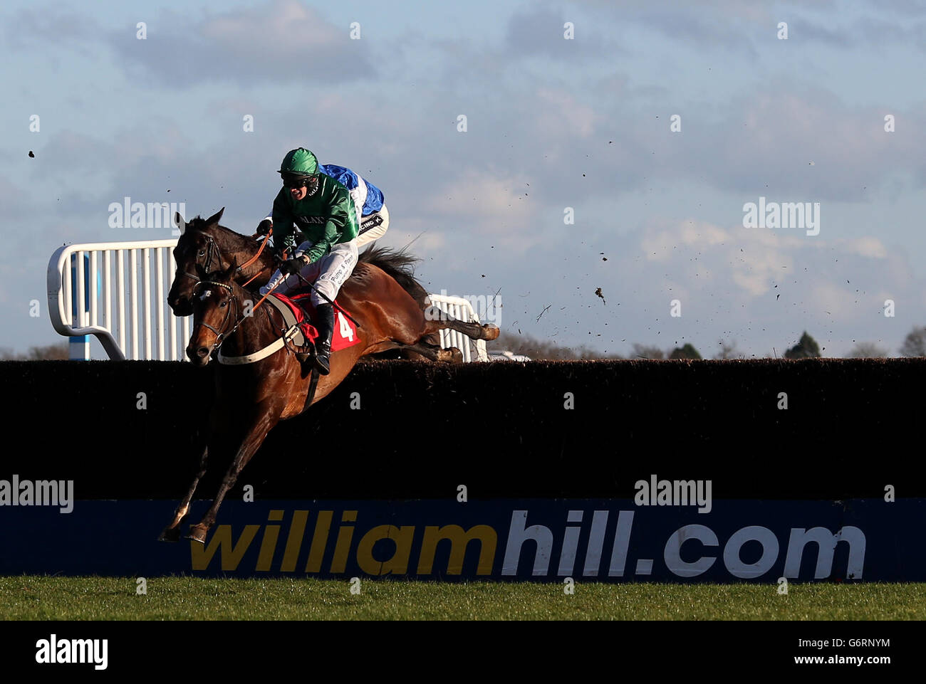 Une Artiste ridden by David Bass jumps the last on the way to winning The Betdaq 25 No Lose Mobile Bet Graduation Chase (Class 2) at Kempton Park Racecourse, Sunbury-on-Thames. Stock Photo