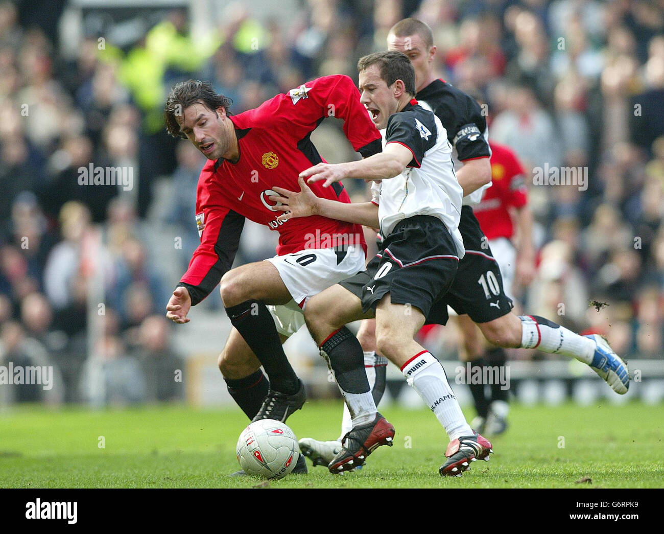 Manchester United's Ruud Van Nistelrooy is watched closely by PSV  Eindhoven's Jurgen Colin during their Vodafone Cup match at Old Trafford in  Manchester. The English and Dutch sides were playing the second