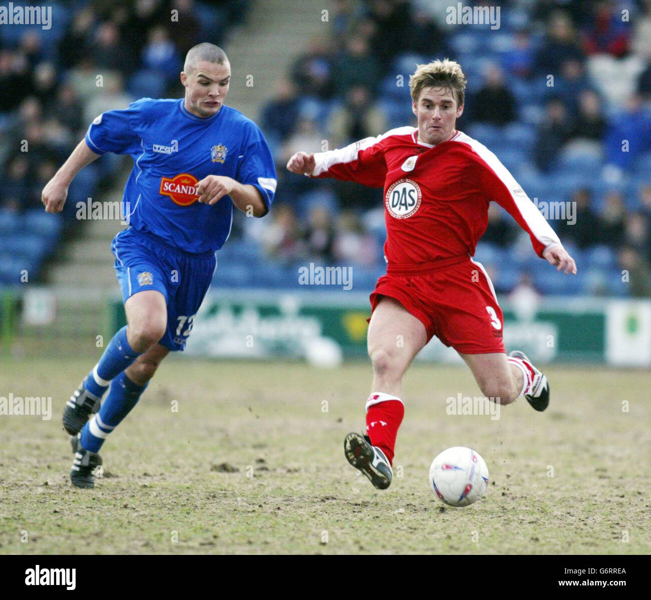 Stockport County's Jim Goodwin (left) closes in on Bristol City's Micky ...