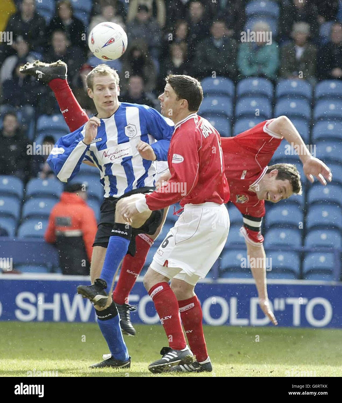 Sheffield Wednesday's Kim Olsen (L) tangles with Barnsley's Antony Kay (R) & Peter Handyside during the Nationwide Division Two match at Hillsborough, Sheffield. NO UNOFFICIAL CLUB WEBSITE USE. Stock Photo