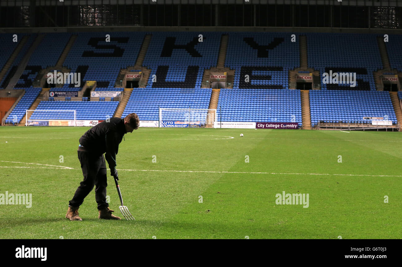 Groundstaff work on the pitch during Leicester City's 'home' game against Manchester United's U21 at Ricoh Arena in Coventry Stock Photo