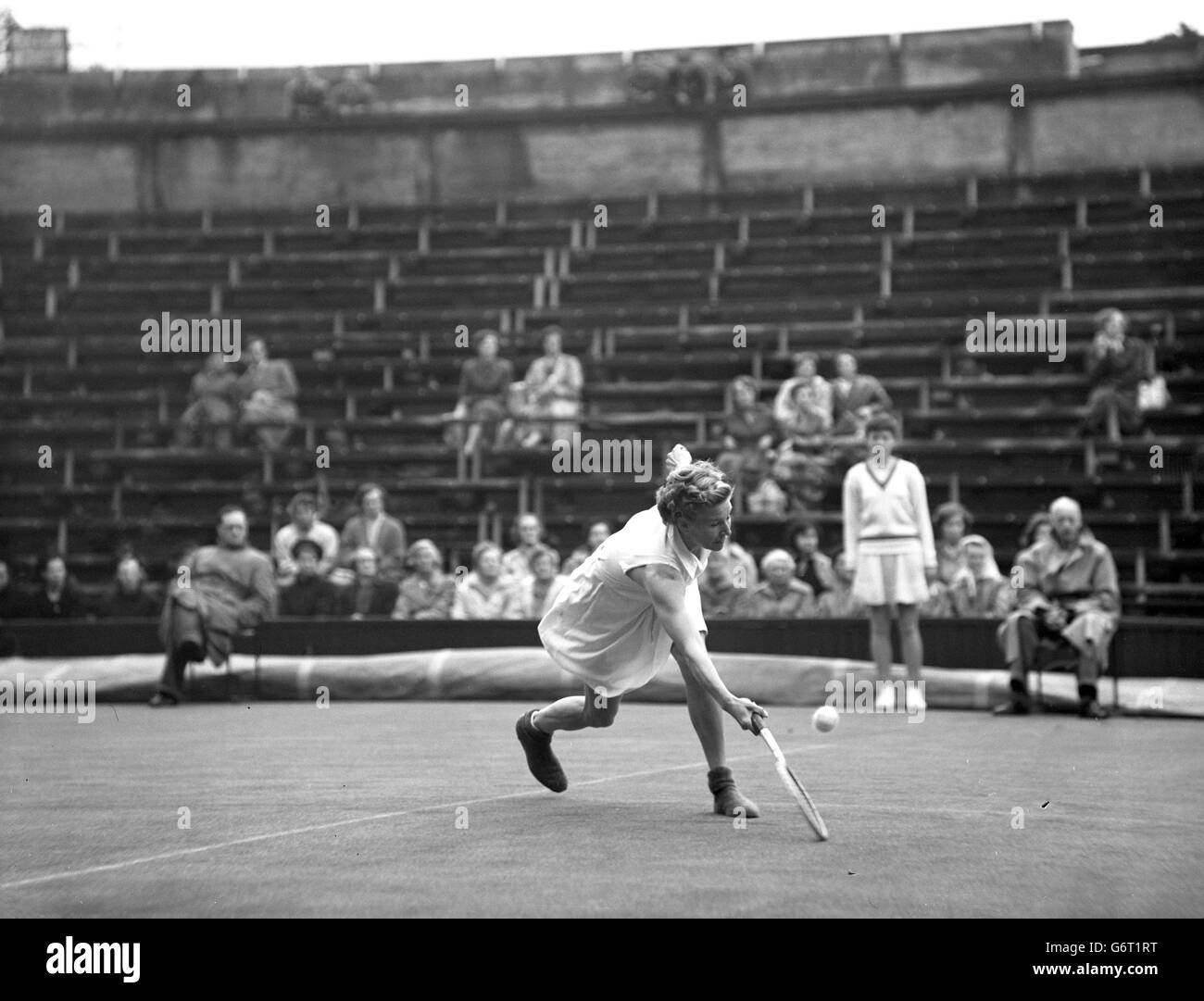 Louise Brough, United States, playing with woollen socks over her shoes to prevent sliding. She won the match 8-6, 6-2. Stock Photo