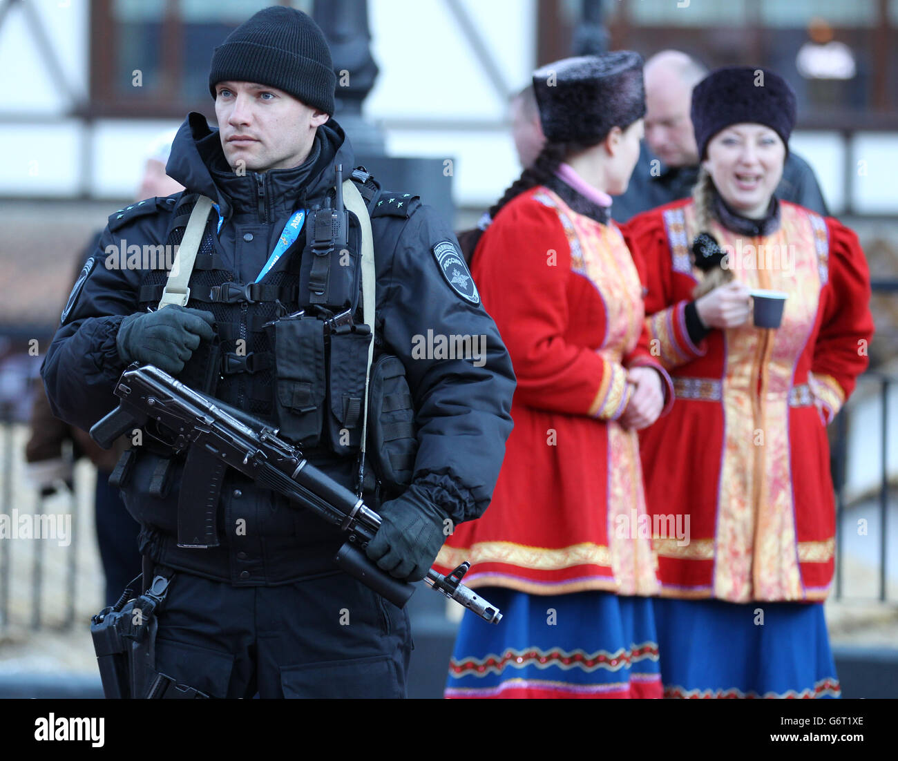 Sochi Winter Olympic Games - Pre-Games activity - Wednesday. Security as The Olympic flame is carried through Rosa Khutor ahead of the start of 2014 Winter Games in Sochi. Stock Photo