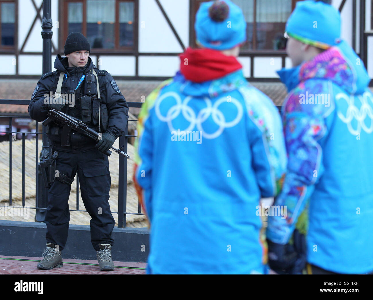 Sochi Winter Olympic Games - Pre-Games activity - Wednesday. Security as The Olympic flame is carried through Rosa Khutor ahead of the start of 2014 Winter Games in Sochi. Stock Photo