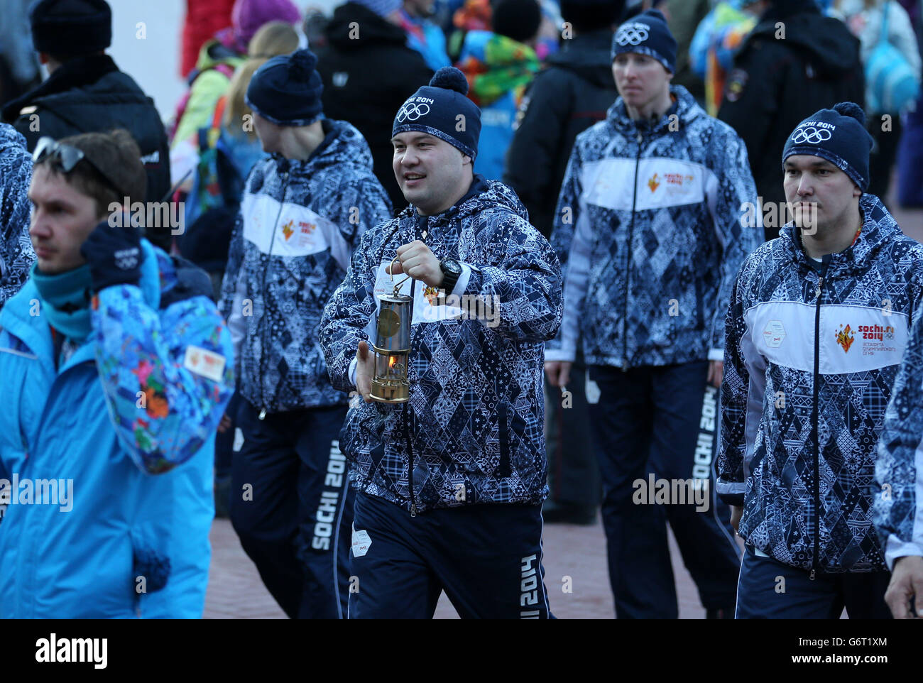 Sochi Winter Olympic Games - Pre-Games activity - Wednesday. The Olympic flame is carried through Rosa Khutor ahead of the start of 2014 Winter Games in Sochi. Stock Photo