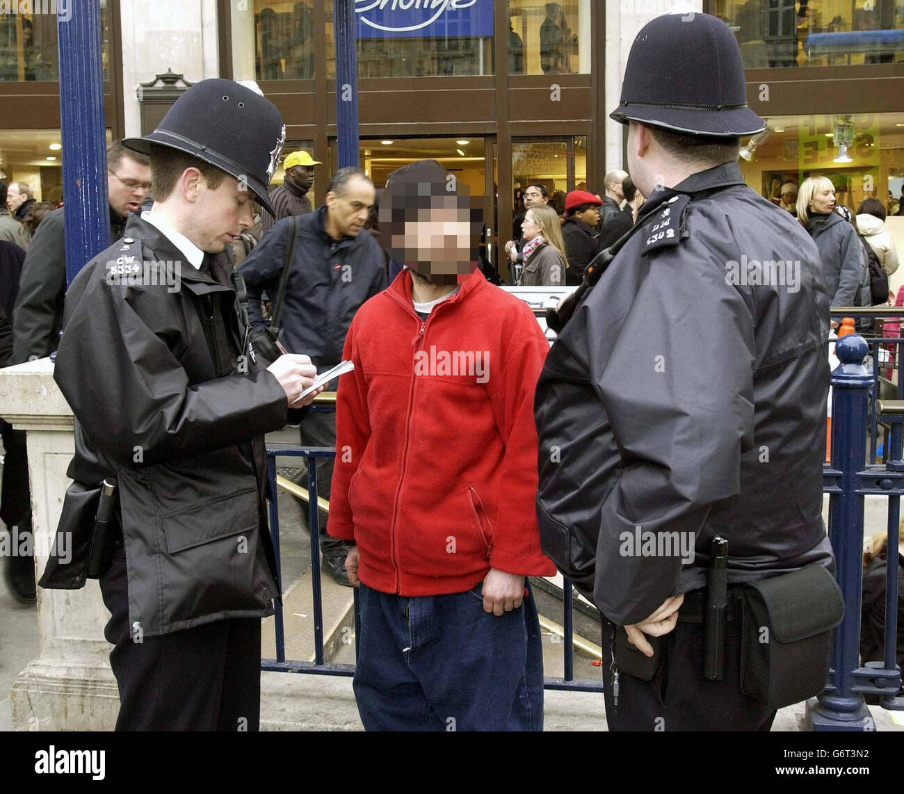 A man is questioned by police who suspect him of begging in Oxford Circus. Fifteen people were arrested on the first night of a controversial drive to clear beggars off the streets of London's West End, organisers said. They were picked up as part of a 48-hour blitz by Westminster Council designed to disrupt and deter begging in the area. POLICE HAVE REQUESTED THAT THE MANS FACE BE PIXELLATED. Stock Photo
