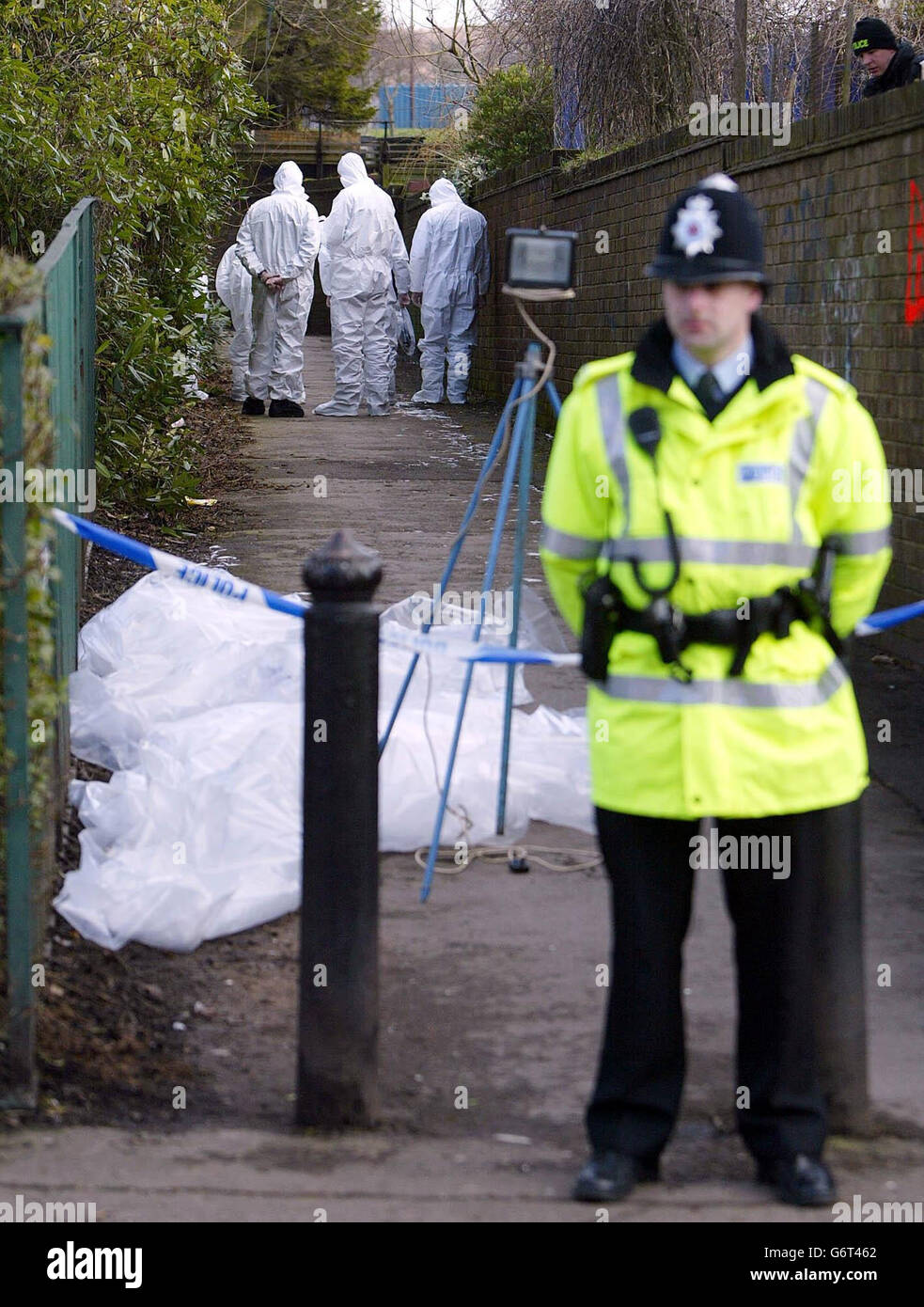 Police forensic officers search an alley on Stratford Road, Chorley, Lancashire after the body of Melanie Horridge was found there on Friday night. Two men were arrested today on suspicion of the murder of Melanie, Lancashire Police said. Stock Photo