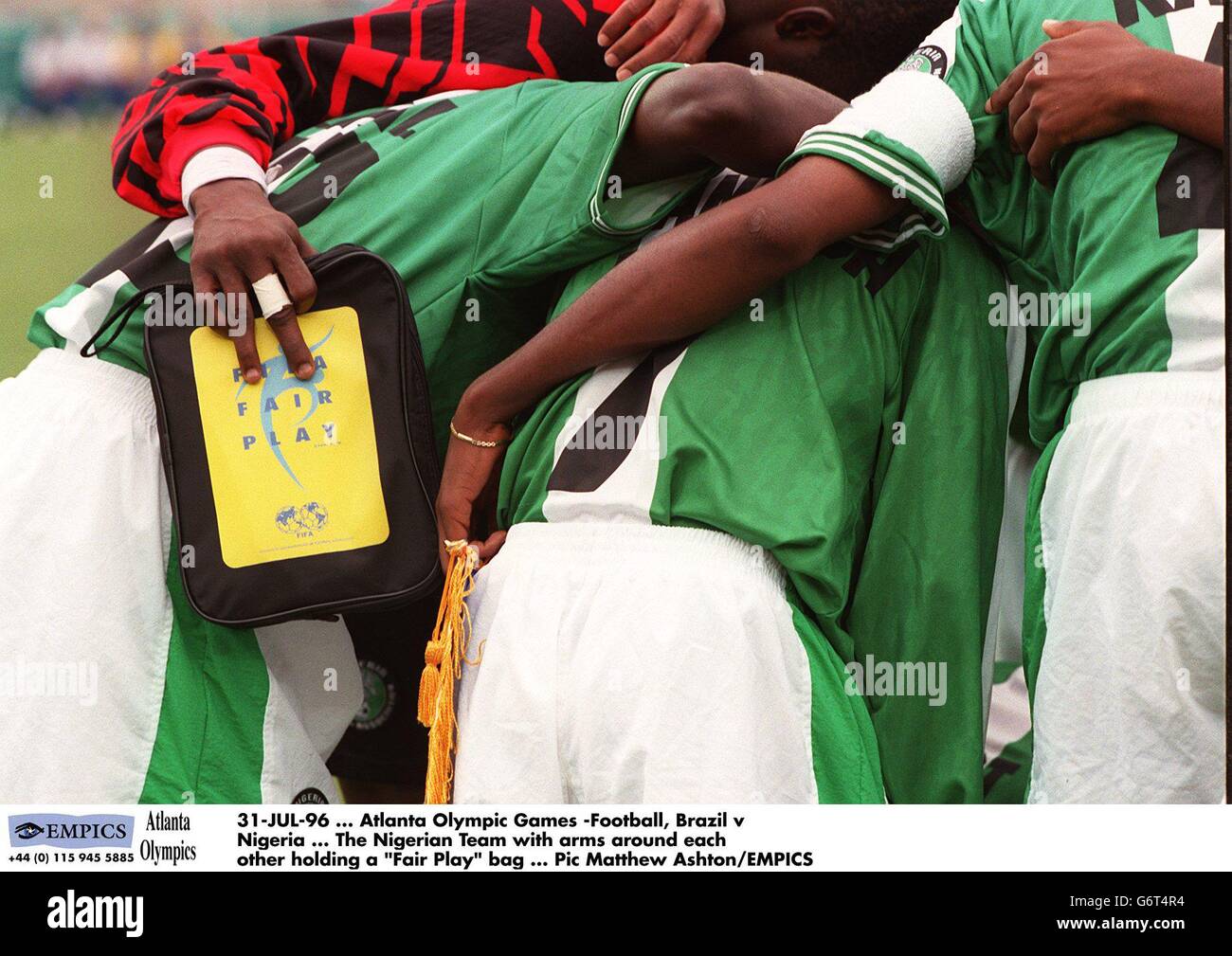 31-JUL-96 ... Atlanta Olympic Games -Soccer, Brazil v Nigeria ... The Nigerian Team with arms around each other holding a Fair Play bag Stock Photo