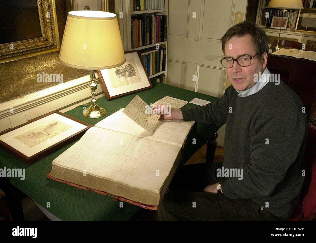 Publisher John Murray examines a letter and a ledger written by Dr Livingstone on his exploratory journey to South Africa at the John Murray Archive in Central London, ahead of a funding announcement to be made by Scottish Executive Culture Minister Frank McAveety at the National Library of Scotland in Edinburgh. The unique collection of writings from some of history's most celebrated authors, explorers and scientists, which has been valued at 45m, is heading home to Scotland. Stock Photo