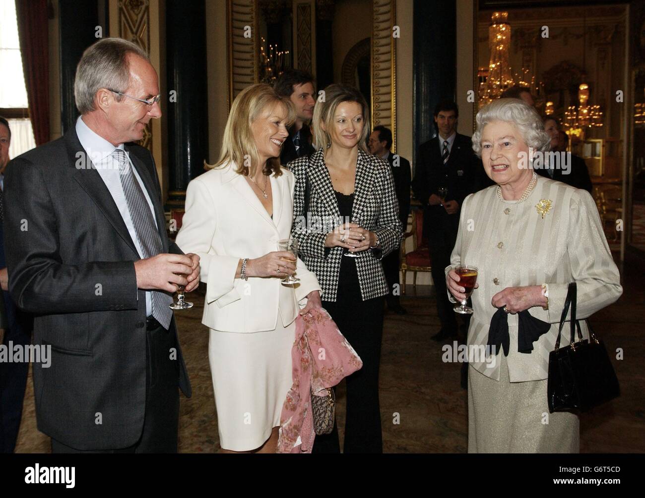 Britain's Queen Elizabeth II meets from left, England's Head Coach Sven-Goran Eriksson, Mrs Susan Davies - wife of David Davies, the FA's Executive Director - and Miss Jane Bateman, Head of International Relations at the English FA, during a reception at Buckingham Palace in London to mark the centenary of FIFA. Stock Photo