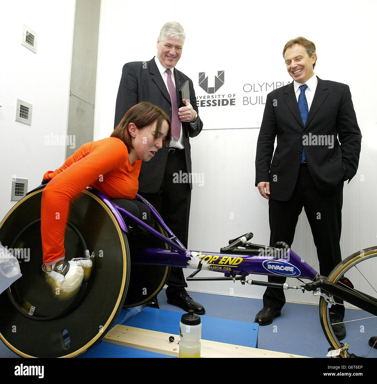 University Vice Chancellor Professor Graham Henderson stands with British Prime Minister Tony Blair (right) as he watches disabled athlete Sarah Loughran train, in the Environmental Chamber, during his visit to the Olympia Building at the University of Teeside in Middlesbrough. Early, in a keynote speech in his constituency, Mr Blair passionately defended the war in Iraq and claimed the twin towers attack of September 11 had come as a 'revelation' that convinced him of the need to tackle rogue states. Stock Photo