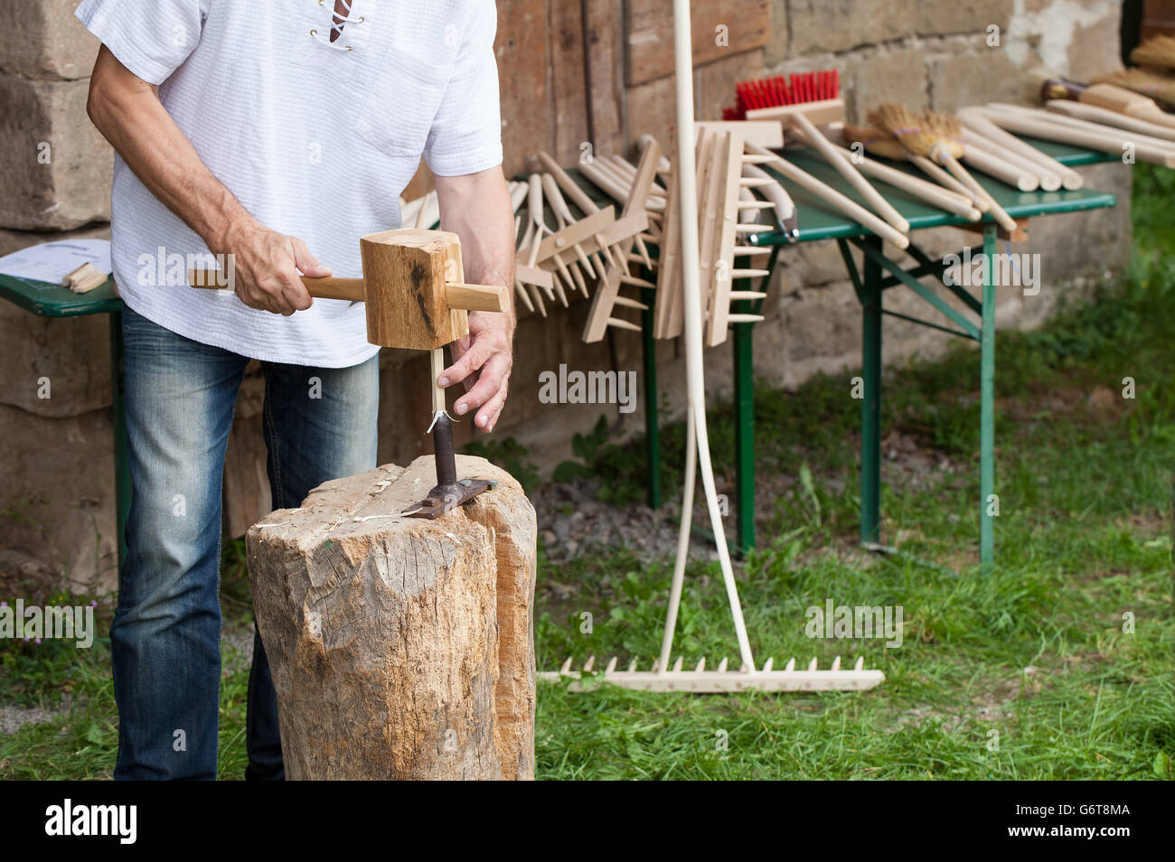 Craftsman produces wooden rake tooth Stock Photo