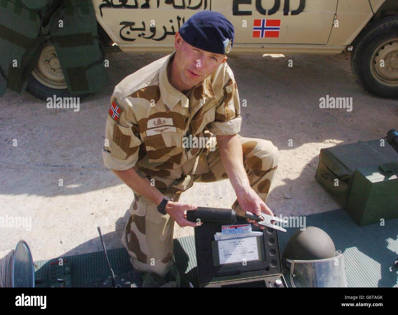 Commander Malkenes, a Commanding Officer for the Norwegian Explosive Ordnance Disposal (EOB) team and part of the Norwegian Engineers Squadron based in Bergen in Norway, describes a tool used to remove fuses in bombs at an Improvised Explosive Devices (IED) base near Basra in southern Iraq. Stock Photo