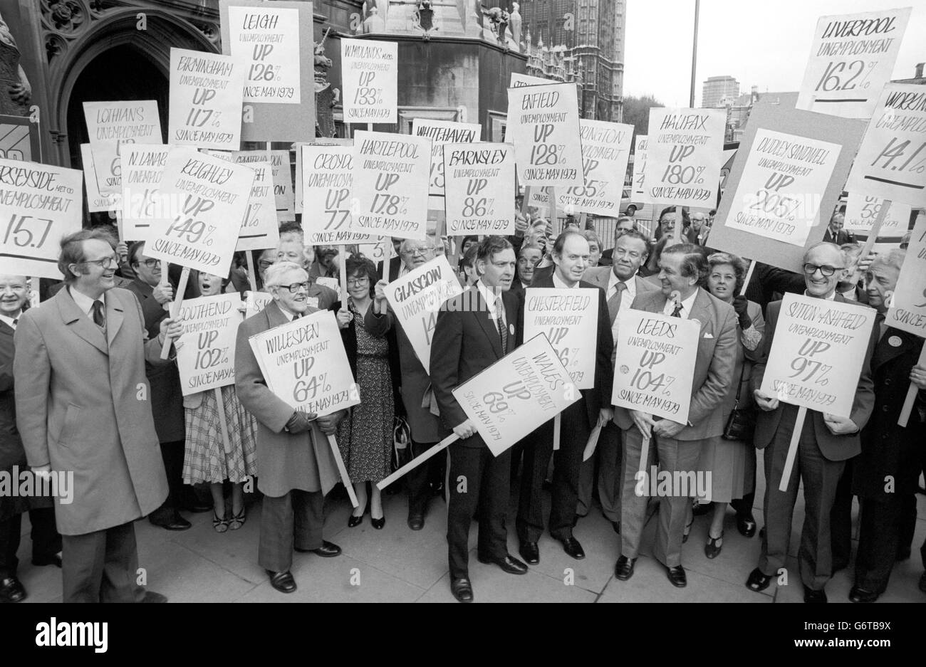 A group of Labour MPs, including banner-carrying Labour MP Denis Healey and Eric Varley (Wales), protesting in London by walking to the Department of Employment to hand in letters complaining of the lack of jobs to Employment Secretary James Prior. The protesters are shown leaving the House of Commons to commence their walk with placards to the department in nearby Tothill Street. Stock Photo