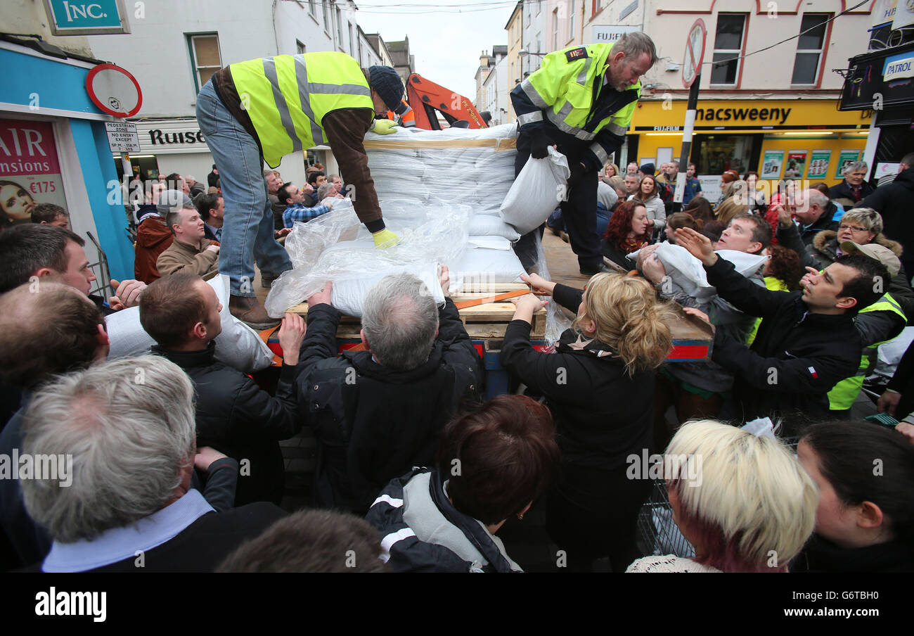 People collect sand bags from Cork County Council workers as they