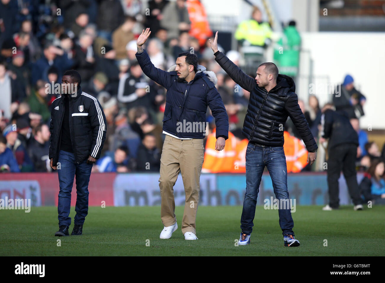 Fulham's new signings Johnny Heitinga (right), Kostas Mitroglou and Larnell Cole (left) wave to fans as they walk onto the pitch prior to the start of the game Stock Photo
