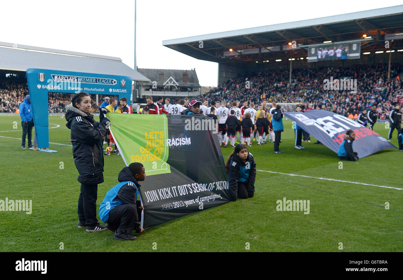 Fulham ball-boys and ball-girls hold up an Kick It Out anti-rascism banner before the game. Stock Photo