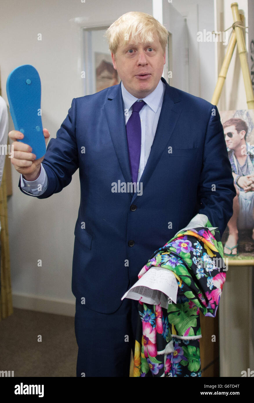 The Mayor of London Boris Johnson meets the founders of the footwear company Gandys Flip Flop, where he was asked to design his own flip flop. Stock Photo