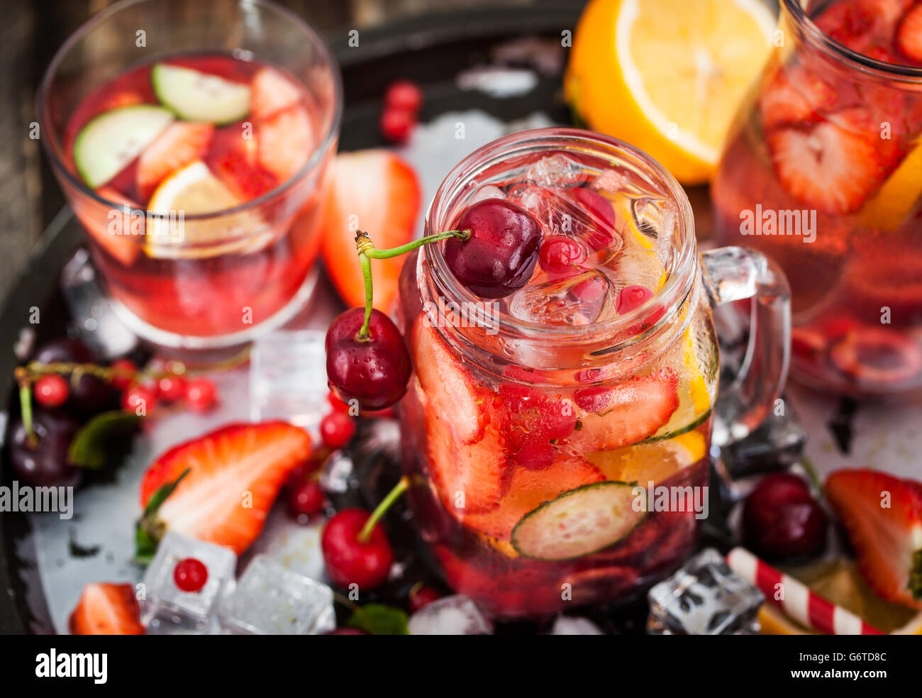 Healthy infused detox water with fresh berries and fruits in mason jar