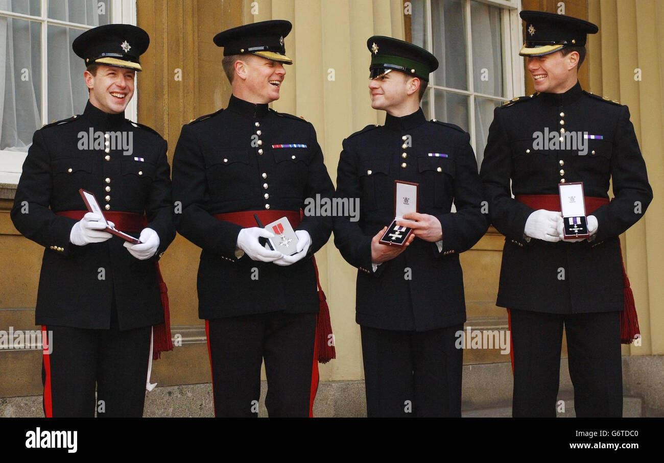 Irish Guards (from left) Lieutenant Thomas Orde-Powlett, Major Peter MacMullan, Guardsman Anton Branchflower and Lieutenant Daniel O'Connell after being decorated by the Queen with Military Crosses, except for Major MacMullen who received an MBE after being decorated by Britain's Queen Elizabeth II at an investiture for services in Iraq at Buckingham Palace, London. Stock Photo