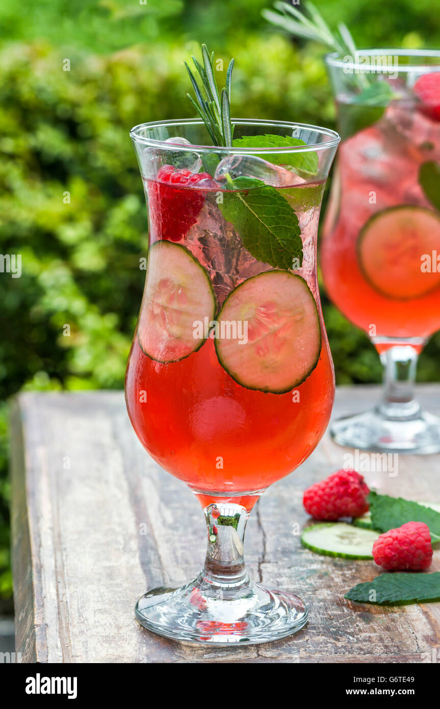 Pink gin and tonic cocktail with raspberries, cucumber and mint Stock ...