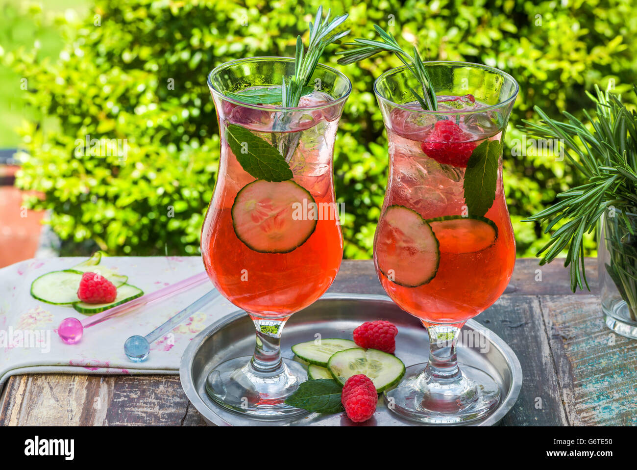 Pink gin and tonic cocktail with raspberries, cucumber and mint Stock