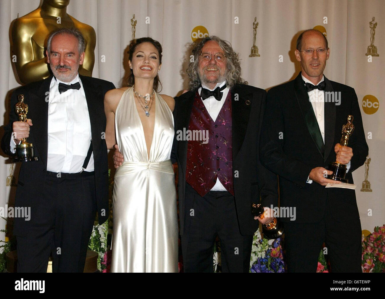 Dan Hennah, Grant Major and Alan Lee with their Oscars for Art Direction, for Lord of the Rings: The Return of the King and actress Angelina Jolie at the Kodak Theatre in Los Angeles during the 76th Academy Awards. Angelina Jolie is wearing a H Stern diamond necklace, worth 1m. Stock Photo