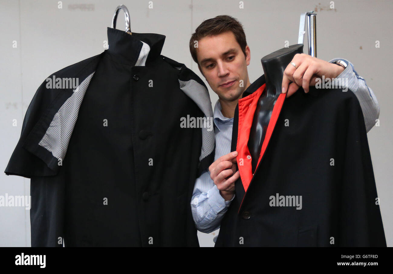 Auctioneer Paul Fairweather with jackets worn by George Harrison (right ...