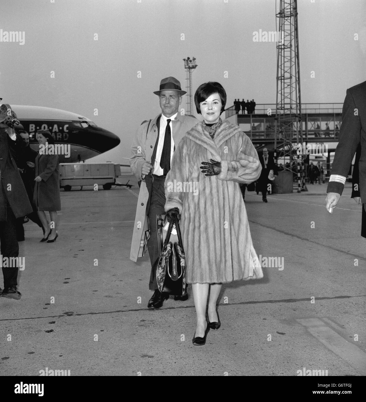 Former child film star Shirley Temple with her husband Charles Black, an electronics engineer, as they leave London Airport for Moscow on a sight-seeing holiday. Shirley, now 37, retired from films 25 years ago. Stock Photo