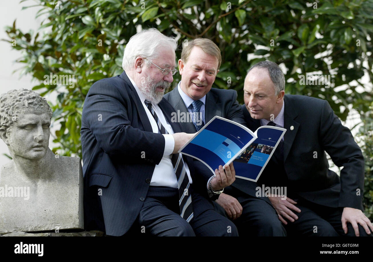 From left to right, William T. McCarter, Chairman of the International Fund for Ireland (IFI), His Excellency Stewart Eldon, British Ambassador to Ireland, and Dermot Ahern T.D., Minister for Communications, Marine and Natural Resources, examine the annual report of the IFI which was launched in Dublin. The IFI spent 30 million (43.7m euro) in supporting 250 new projects throughout the region, with over 90% of the money committed to the most disadvantaged areas, according to the report. Stock Photo