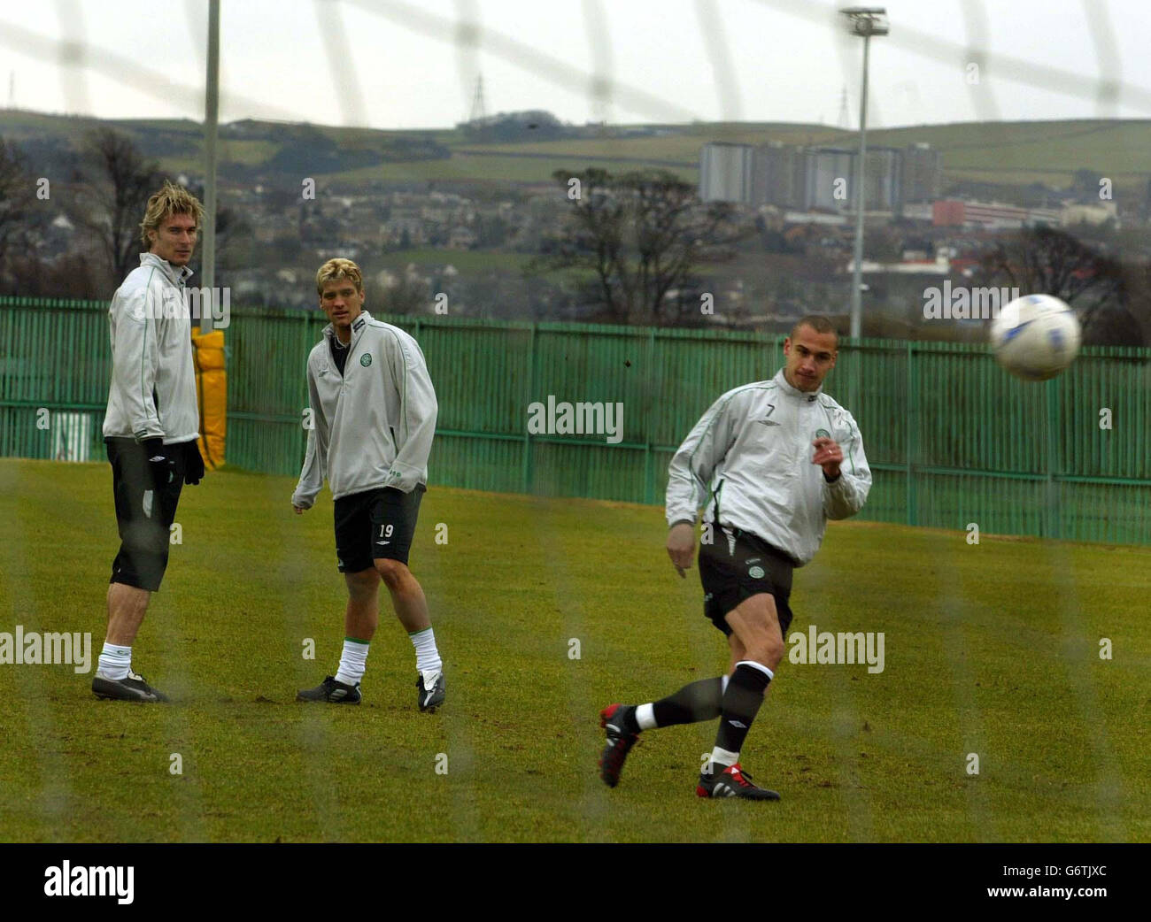 Henrik Larsson taking a shot at goal with Stilian Petrov (middle) and Stanislav Varga during training at Celtics Social Club ground before the game against Barcelona in the fourth-round first leg Uefa Cup tie at Parkhead football ground in Glasgow. Stock Photo