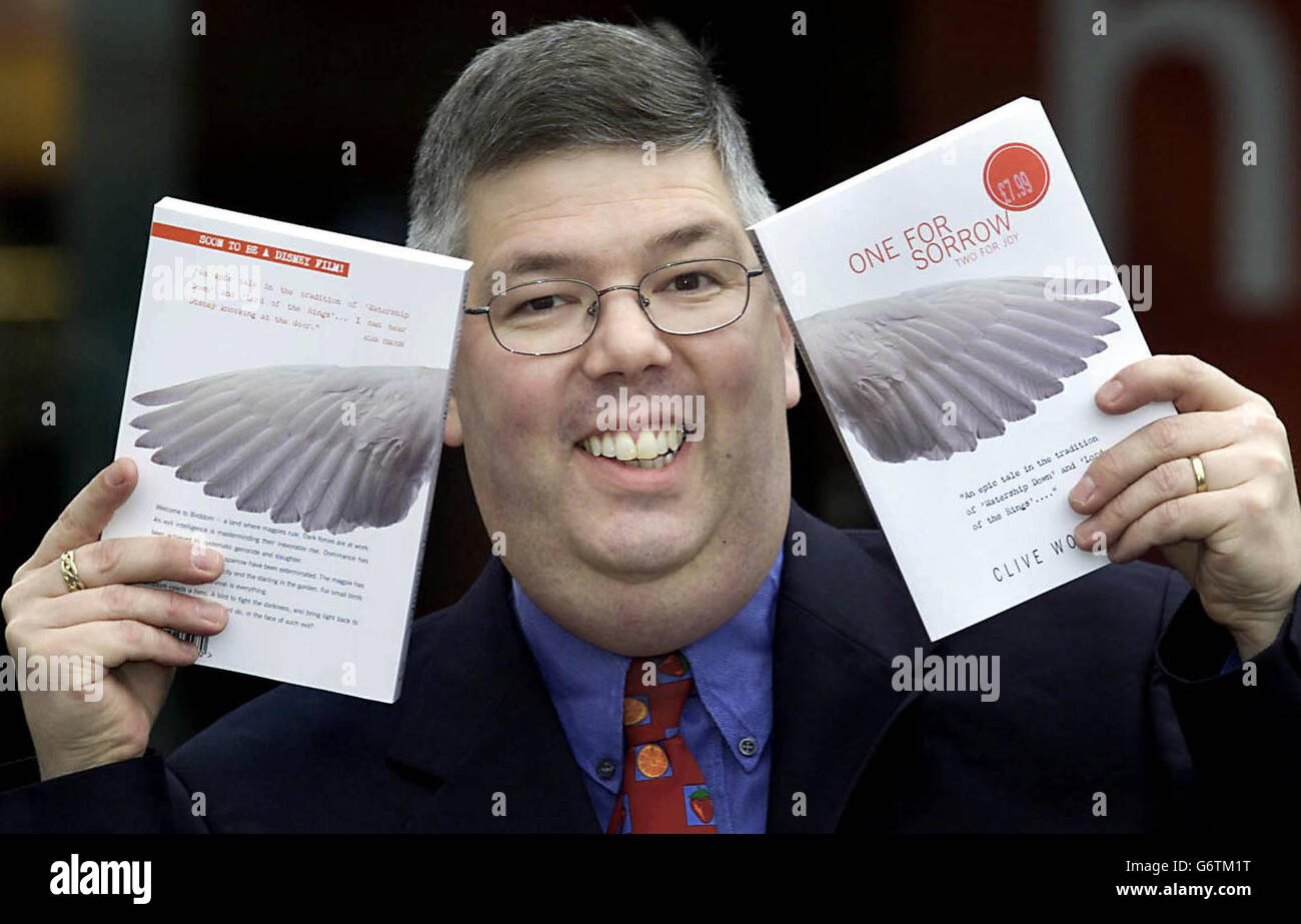 Sainsbury's fruit and veg Manager Clive Woodall, 47, holds his debut book 'One For Sorrow' at Sainsbury's Supermarket in Hitcham, Hertfordshire, after selling the book to Disney for $1 million. Franc Roddam, director of the cult classic Quadrophenia and producer of numerous TV shows, bought the rights and then sold them to Disney after being shown the manuscript by his bank manager, who was in turn a friend of Clive's wife. Stock Photo