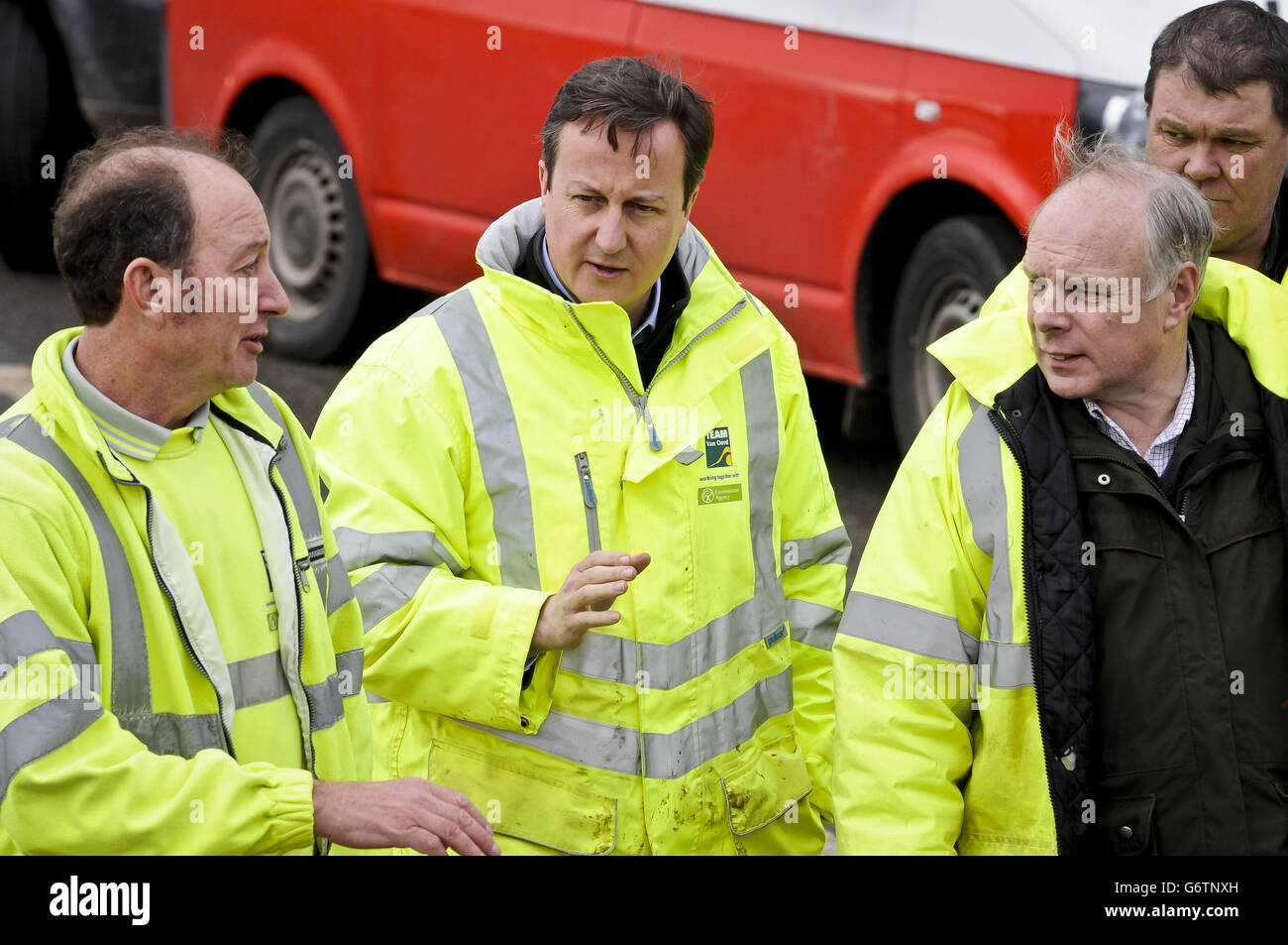 Prime Minister David Cameron (centre) arrives at a pumping operation on the Somerset Levels near Othery, Bridgwater, during a visit to see the extent of the flooding in the UK, as he announced that the Treasury will cover the cost of council tax rebates for flooding victims in England and warned that recovering from the crisis would be a 'very long haul'. Stock Photo